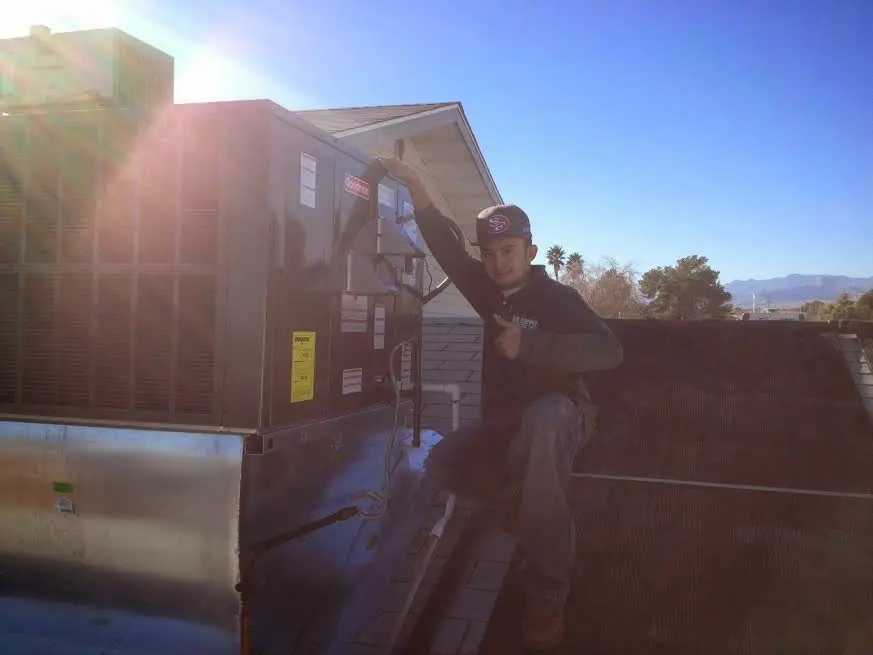 HVAC technician performing Air Duct Cleaning on a rooftop unit in Union City